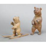 A carved Swiss figure of a skiing bear 14cm (no poles) together with a ditto of a standing bear 19cm