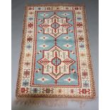 A blue, white and brown ground Afghan rug with 2 stylised medallions within a multi row border 201cm