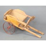 Swallow Toys, a child's pine tipping hand cart with metal wheels 27cm h x 54cm l x 25cm w, having