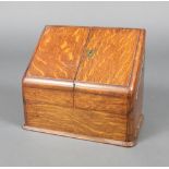 A Victorian oak wedge shaped stationery box with hinged lid and stepped interior 24cm x 29cm x