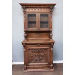 A 19th Century Dutch carved oak display cabinet on cabinet with moulded cornice and lion ring masks,