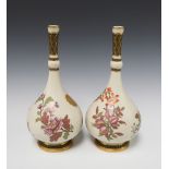 A pair of Victorian Royal Worcester blush ivory and floral patterned twin handled club shaped vases,