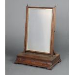 An 18th/19th Century rectangular plate dressing table mirror contained in a mahogany swing frame