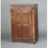 An 18th/19th Century carved oak cabinet constructed of 18th Century and later timber, the interior