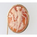 A yellow metal stamped 14k oval cameo brooch decorated with a lady and cherub