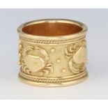 Elizabeth Gage, a yellow metal 18ct wide wedding band decorated with the star sign Cancer, 17mm