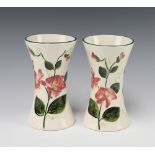 A pair of Griselda Hill pottery vases decorated flowers 17cm, bases marked SD Some crazing