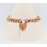 A 9ct yellow gold bracelet with heart padlock, 18cm, 12 grams