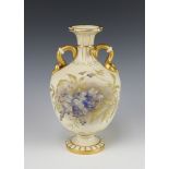 A Victorian Royal Worcester blush ivory and floral patterned handled vase with gilt cobra handles,
