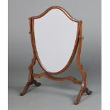 A Sheraton style shield shaped plate dressing table mirror contained in a mahogany swing frame