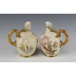 A pair of Victorian Royal Worcester blush ivory ground jugs, the base with purple Worcester mark,