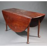 A Georgian mahogany oval drop flap dining table raised on club supports with pad feet 72cm h x 139cm