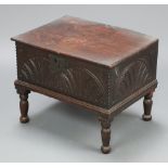 An 18th Century carved oak bible box with hinged lid and iron lock front, raised on later turned