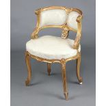 A 19th Century gilt painted Louis style tub back salon chair with overstuffed seat, raised on