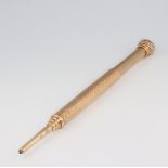 A yellow metal engraved 14kt engine turned propelling pencil, 14.5cm, gross weight 35.7 grams