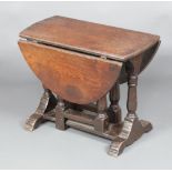 An Ipswich style oak oval drop flap, gate leg, tea table raised on turned supports 110cm h x 100cm w