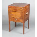 A Georgian mahogany enclosed wash stand the hinged lid revealing a recess, 2 brass carrying