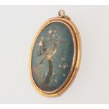 A yellow metal cloisonne pendant depicting a bird on a branch 35mm, gross weight 8 grams