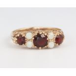 A Victorian style 9ct yellow gold garnet and opal ring, 2.4 grams, size O 1/2