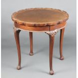 A circular Chippendale style mahogany occasional table with pie crust edge, raised on club supports,