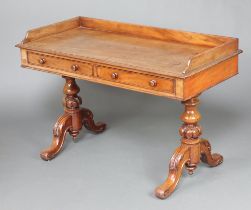 A Victorian bleached mahogany washstand/writing table with 3/4 gallery, fitted 2 drawers, raised