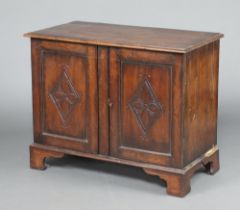 A carved oak cabinet formed from old timber, the top formed from 4 planks, raised on bracket feet