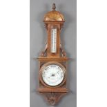 An Edwardian aneroid barometer and thermometer with porcelain dial marked W Bateman Opticians,