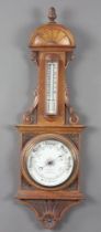 An Edwardian aneroid barometer and thermometer with porcelain dial marked W Bateman Opticians,