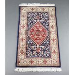 A blue and floral ground Persian rug 138cm x 78cm This rug has some minor wear to one side f the