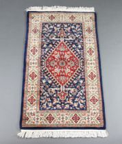 A blue and floral ground Persian rug 138cm x 78cm This rug has some minor wear to one side f the