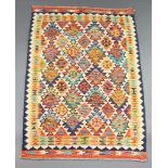 A turquoise, white and yellow ground Chobi Kilim rug with all over geometric designs 157cm x 107cm