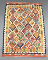 A turquoise, white and yellow ground Chobi Kilim rug with all over geometric designs 157cm x 107cm