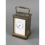 A 19th Century French 8 day carriage timepiece with 7cm enamelled dial contained in a gilt metal