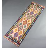 A white, brown and yellow ground Chobi Kilim runner with over all geometric designs 200cm x 63cm
