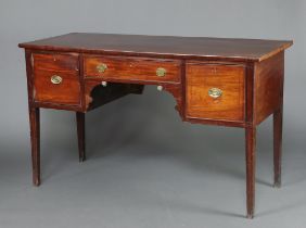 A Georgian mahogany sideboard fitted a central drawer flanked by a drawer and cupboard with brass