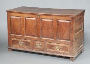 A 17th/18th Century oak mule chest with hinged lid and iron lock and brass escutcheon, the base