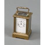 A reproduction carriage timepiece with 3cm enamelled dial, contained in a gilt metal case 7cm h x