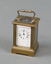 A reproduction carriage timepiece with 3cm enamelled dial, contained in a gilt metal case 7cm h x