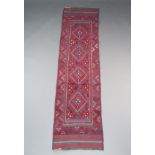 A red and blue ground Meshwani runner with 4 diamonds to the centre 248cm x 63cm