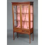 An Edwardian inlaid mahogany bookcase with moulded cornice, fitted shelves enclosed by astragal