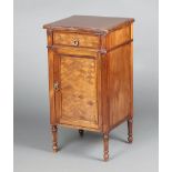 A French style mahogany and marquetry bedside cabinet fitted a drawer above panelled door, raised on