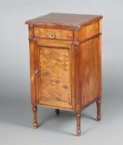 A French style mahogany and marquetry bedside cabinet fitted a drawer above panelled door, raised on