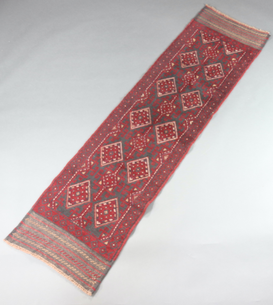 A red and blue ground Meshwani runner with 10 diamonds to the centre 236cm x 60cm