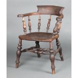 A 19th Century elm smoker's bow armchair with solid seat and bobbin turned decoration, double H