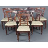 A set of 8 Victorian carved walnut bar back dining chairs, the mid rail with bobbin turned