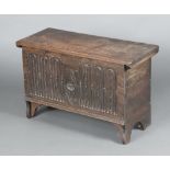 A Tudor 1930's 17th Century style coffer of panelled construction with arcaded decoration and hinged