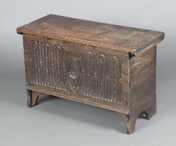 A Tudor 1930's 17th Century style coffer of panelled construction with arcaded decoration and hinged