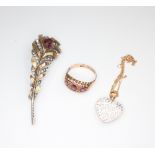 A 9ct yellow gold ruby ring, size O, a paste set feather brooch and a paste set heart shaped pendant