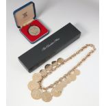 A Franklin Mint gilt coin necklace together with a 1977 silver crown