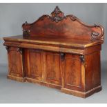 A Victorian carved mahogany sideboard with carved shaped back, the base fitted 3 drawers above